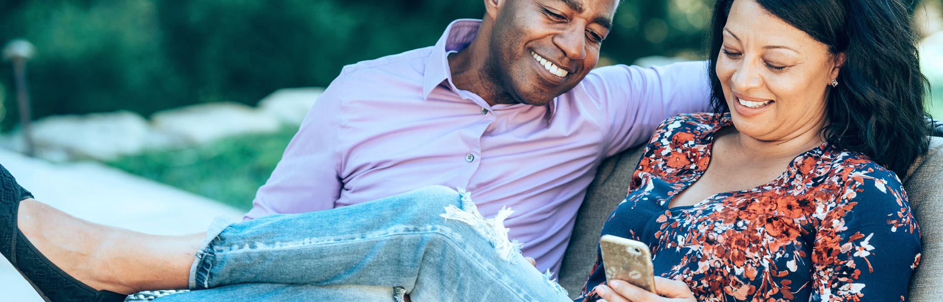 Happy couple using mobile banking