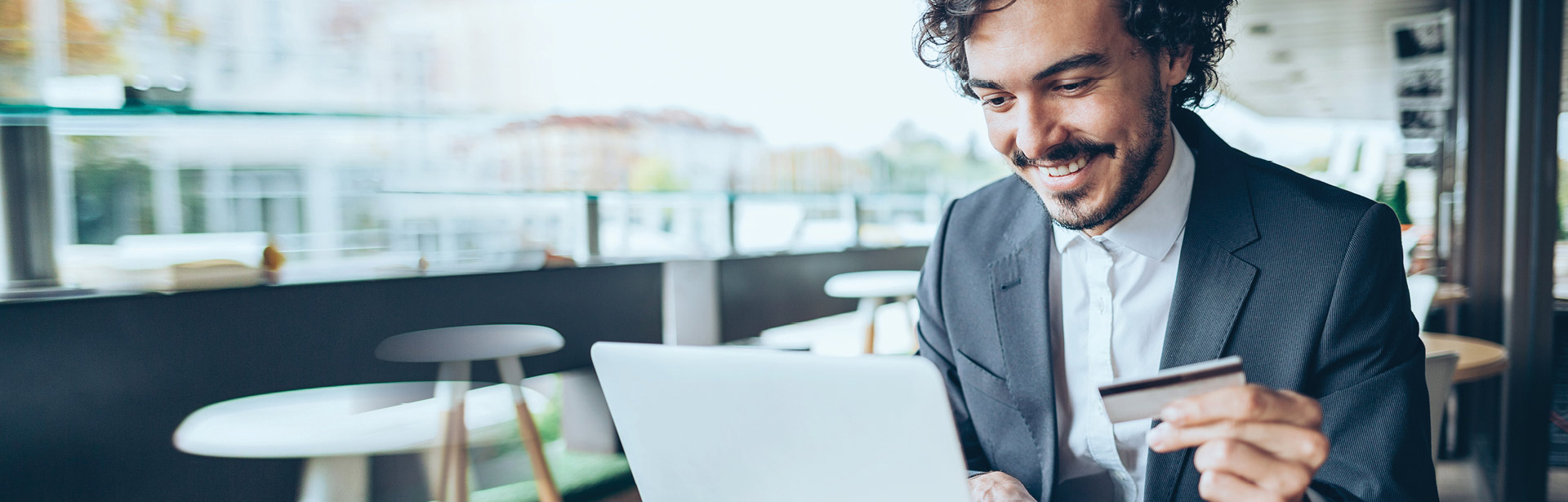 Man holding credit card reading privacy security information